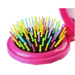 A portable folding hair brush in pink with a mirror, featuring colourful bristles in various pastel shades.
