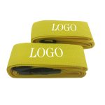 Yellow luggage straps with plastic buckles, featuring a logo on them. Two straps are displayed side by side.