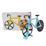 A bicycle-shaped pizza cutter in blue and yellow, displayed with its packaging in the background.