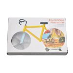 A bicycle-shaped pizza cutter in a black and yellow box, featuring a blue wheel and a handle resembling handlebars.