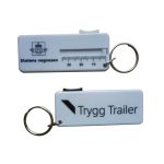 A white plastic tire gauge with a keyring attachment, featuring measurement markings and a logo on one side.