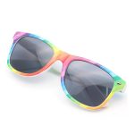 Rainbow sunglasses with a geometric pattern featuring vibrant colours and dark lenses. The frames have a logo.