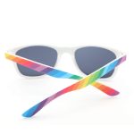 Rainbow sunglasses with white frames and multicoloured arms in shades of pink, blue, green, and yellow.