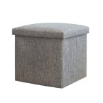 A grey foldable storage ottoman with a cushioned top, featuring a simple, textured fabric design.