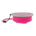 A pink portable silicone cup with a clear lid and a strap, designed for travel use.