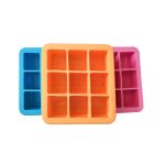 Three silicone ice cube trays in blue, orange, and pink, featuring multiple compartments for ice cubes.