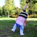 A Halloween unicorn inflatable costume in pink and white, featuring a pointed horn and colourful accents.