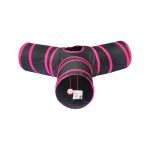 A collapsible pet play tunnel tube in black with pink stripes, featuring a central opening and a hanging toy.