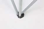 A close-up of a silver folding beach chair leg connector, featuring a black plastic base.
