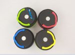 Four portable camping lights in green, blue, red, and yellow with black bases, featuring logos on some.