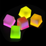 Light up ice cubes in pink, yellow, and green, featuring a bright, glowing design. Includes a logo in the corner.