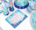 A set of customised disposable party tableware featuring blue and aqua designs, including cups, plates, and an RSVP card.