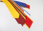 A collection of graduation stoles in various colours, arranged in a fan shape, featuring a logo on some.