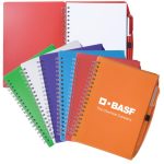 Spiral notebooks in various colours including red, green, blue, purple, and orange, accompanied by a pen, featuring a logo.