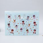 A light blue document envelope featuring assorted printed images and confetti-like decorations throughout.