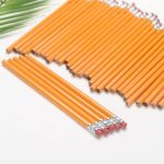 A collection of round orange pencils with erasers, featuring a silver ferrule and visible graphite tips.