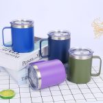 A collection of four double wall stainless steel vacuum insulated mugs in blue, navy, green, and purple. Each has a clear lid and a handle.