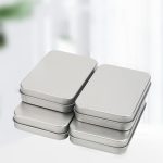 A set of silver tinplate boxes stacked together, featuring a smooth finish and rectangular shape.
