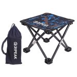 A collapsible camping stool in black and blue with a carrying bag, featuring a logo on the bag.