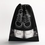 A black non-woven drawstring bag featuring a clear window, displaying white sneakers with a design of shoes on the front.