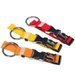 Three luggage belts in red, yellow, and orange, each with a metal ring and plastic buckle. The belts feature a logo.