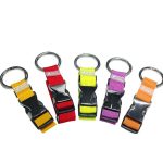 A set of four luggage belts in red, yellow, purple, and orange, each with a metal loop and a logo.