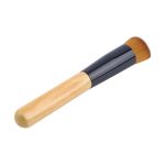 A makeup brush with a wooden handle and a black ferrule, featuring soft bristles for application.