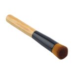 A makeup brush with a wooden handle and a black ferrule, featuring a soft, rounded bristle head.