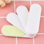 A Nail File Set featuring three white files with a green surface, ideal for personal grooming.
