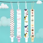 A baby pacifier chain holder set with four colourful designs featuring polka dots, clouds, dinosaurs, and sun motifs.