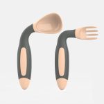 A grey and beige baby fork and spoon set with ergonomic handles. The spoon has a rounded scoop, and the fork features three prongs.