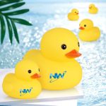 A pair of yellow rubber ducks with a logo, floating on a shimmering water surface.
