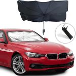 A car windshield sunshade in black, displayed above a red car, featuring an umbrella design and a carrying pouch.