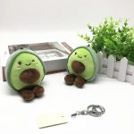 A pair of green avocado plush dolls with brown accents, featuring a keychain attachment.