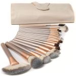 An 18-piece makeup brush set in rose gold and silver, featuring a beige storage pouch.