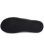 A black sole of a two-tone memory foam slipper featuring a textured design and logo.