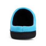 A blue two-tone memory foam slipper with a black sole, featuring a rounded opening. It has a simple design and a logo.