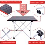 A portable camping table with a dull-polished aluminium top, sturdy frame, and black anti-slip leg caps.