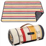 A striped picnic blanket in red, yellow, and navy, rolled up with a handle for easy carrying.