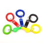 A set of novelty whistles with colourful coiled grips in red, blue, black, green, and yellow. Each whistle has a keyring attachment.
