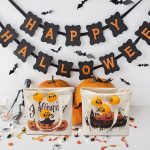A cream reusable canvas tote bag featuring Halloween-themed designs, with pumpkins and decorations, alongside orange pumpkins.