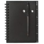 A black spiral notebook with a pen attached, featuring a ruler along the edge.