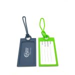 Two silicone luggage tags in navy blue and bright green, featuring a branding logo and space for personal information.