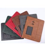 A selection of mouse pads in green, red, brown, grey, and black, featuring a pen holder and a branding logo.
