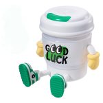 A coffee cup-shaped lamp and Bluetooth speaker in white, with green accents and arms, featuring a 'Good Luck' logo.