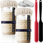 A 32 oz. Mason fermenter jar set with measuring markings, two lids, and silicone spatulas in red and black.