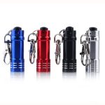 A set of four mini LED flashlights in blue, red, black, and silver, each with a keychain attachment.