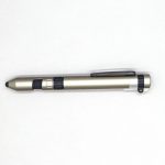 A gold and black 6-in-1 multi-tool pen featuring various functionalities and a clip for easy attachment.