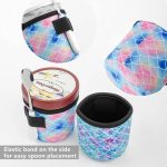 A drink bottle holder featuring a mermaid scale design in pink and blue, with an elastic band for spoon placement.