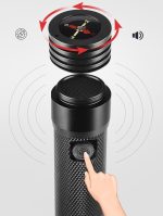 A black flashlight features a power bank function and a built-in compass on the top. It has a textured grip.